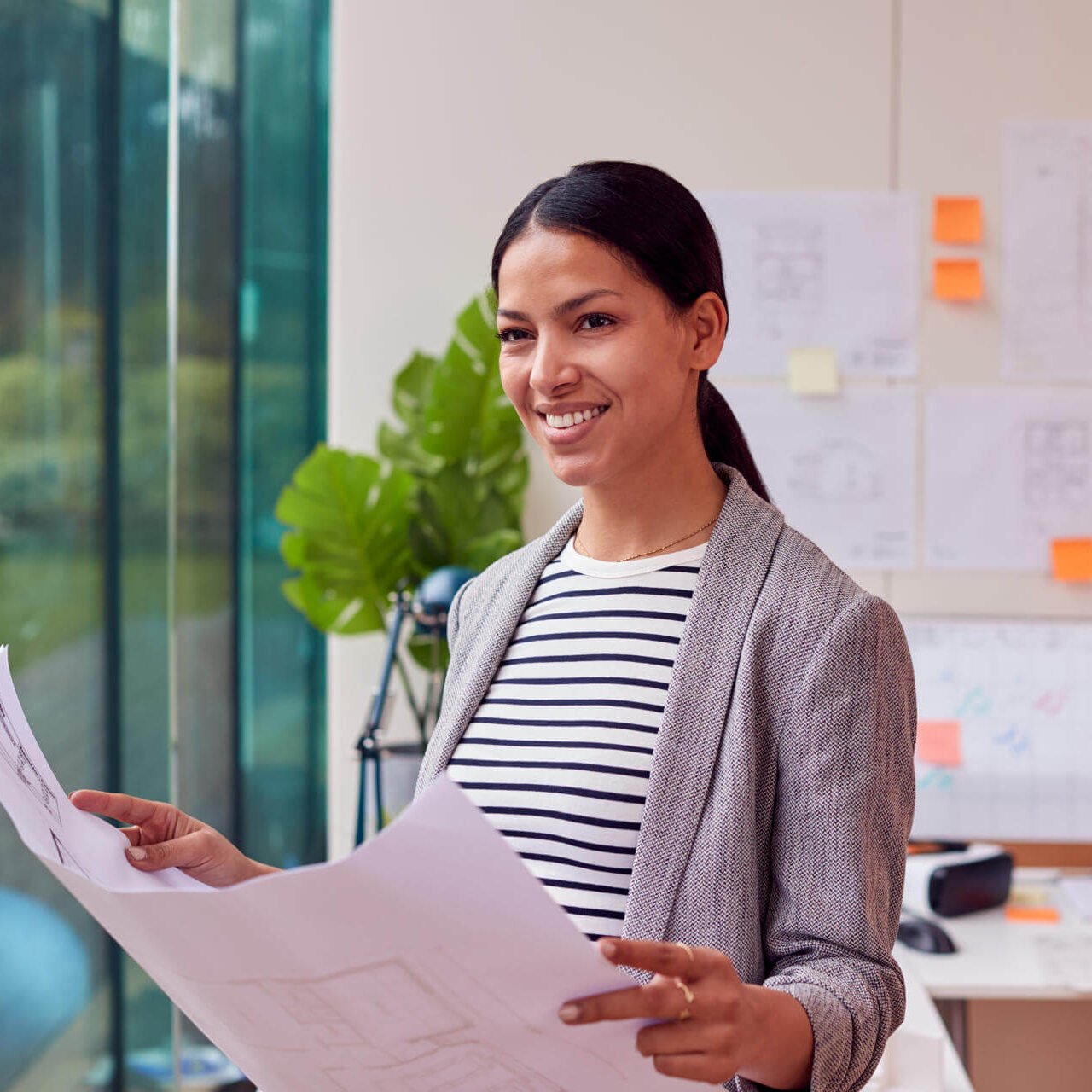female-architect-standing-in-office-looking-at-bui-2024-10-22-13-42-48-utc-e1751518727306.jpg